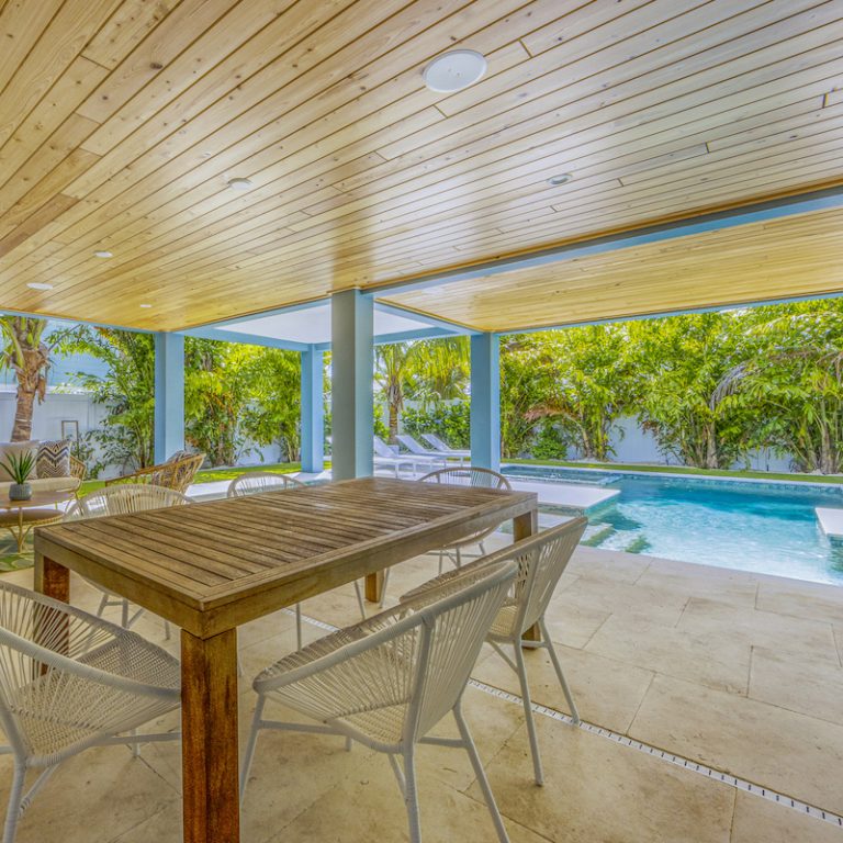 Covered table next to luxury pool