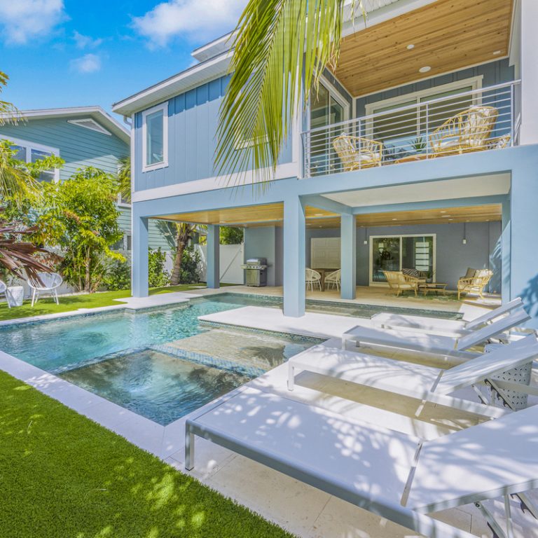 Poolside lounge chairs outside of our luxury beach home